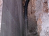 The pipe behind the retaining wall to carry away surface water