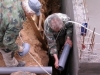 The \'plumbist\' fitting the sewage pipe at the top of the retaining wall before everything gets covered in concrete